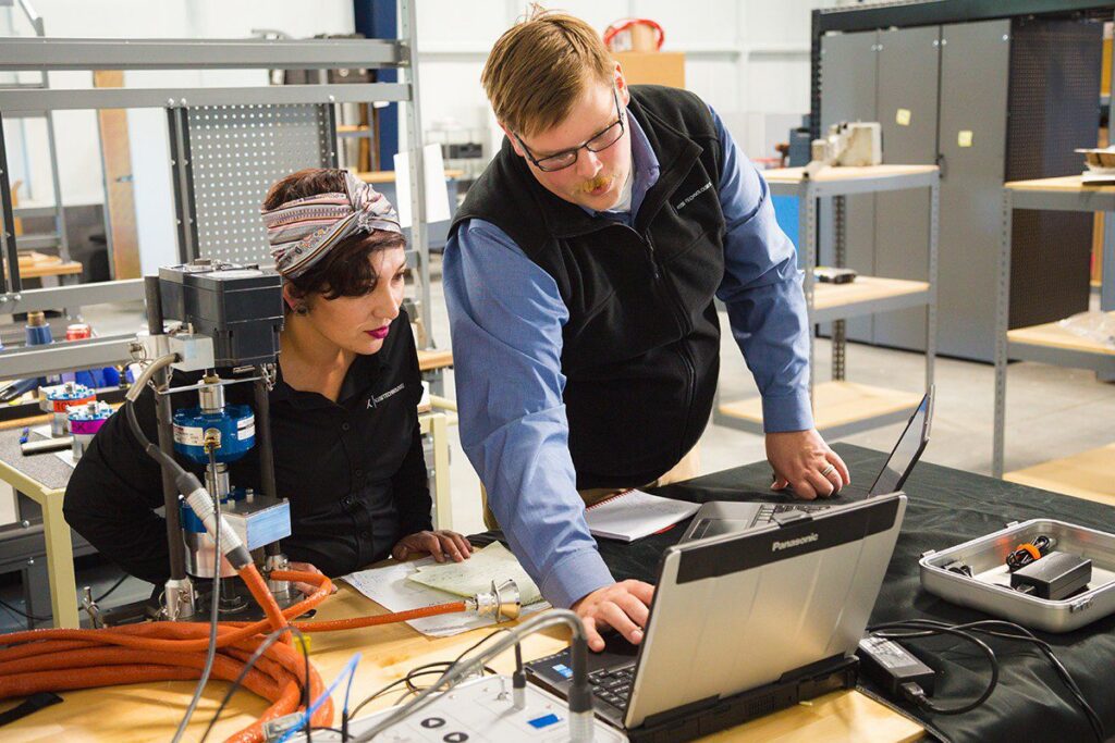 technicians looking at laptop
